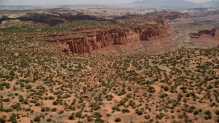 AX130_257E - 5.5K aerial stock footage approach and pan across mesa near Mummy Cliff, Capitol Reef National Park, Utah
