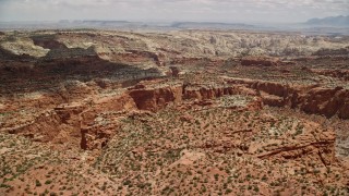 AX130_259E - 5.5K aerial stock footage of flying by canyons and mesas, Capitol Reef National Park, Utah