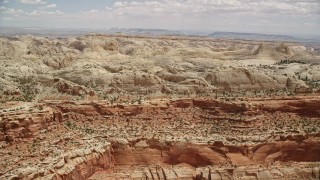AX130_264E - 5.5K aerial stock footage of passing by the Waterpocket Fold rock formations, Capitol Reef National Park, Utah
