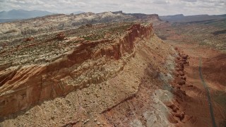 AX130_268E - 5.5K aerial stock footage of approaching side of a mesa, Capitol Reef National Park, Utah