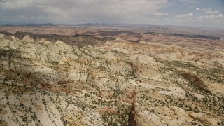 AX130_285E - 5.5K aerial stock footage passing the Waterpocket Fold rock formations, Capitol Reef National Park, Utah