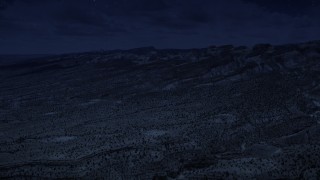 AX130_300_DFN - Aerial stock footage of 4K day for night color corrected aerial footage approach the Waterpocket Fold rock formations, Capitol Reef National Park, Utah