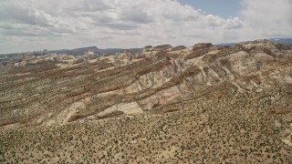 AX130_302E - 5.5K aerial stock footage approach the Waterpocket Fold rock formations, Capitol Reef National Park, Utah