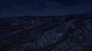 AX130_303_DFN - Aerial stock footage of 4K day for night color corrected aerial footage of the Waterpocket Fold rock formations, Capitol Reef National Park, Utah
