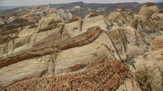 AX130_306E - 5.5K stock footage video of flying over the Waterpocket Fold's rugged rock formations, Capitol Reef National Park, Utah