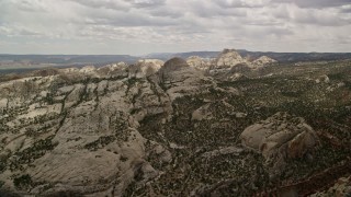 AX130_319E - 5.5K aerial stock footage approach and fly over Waterpocket Fold rock formations and canyons, Capitol Reef National Park, Utah