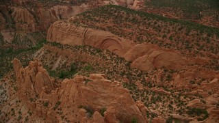 AX130_335 - 5.5K aerial stock footage of flying by a butte, near mesas, Capitol Reef National Park, Utah