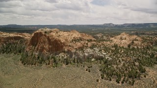 AX130_342 - 5.5K aerial stock footage of orbiting desert mountains, surrounded by vegetation, Dixie National Forest, Utah
