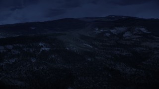 AX130_350_DFN - Aerial stock footage of 4K day for night color corrected aerial footage of flying by low, green mountains, Dixie National Forest, Utah