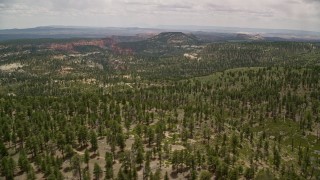 AX130_357 - 5.5K aerial stock footage of flying by mountains and valleys, Dixie National Forest, Utah