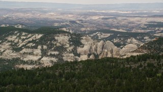 AX130_362E - 5.5K aerial stock footage of flying by mountains, rock formations, Dixie National Forest, Utah