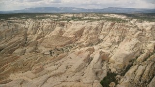 AX130_384E - 5.5K aerial stock footage approach and fly over a canyon in Grand Staircase-Escalante National Monument, Utah