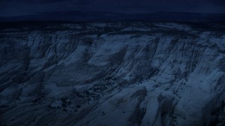 AX130_384_DFN - Aerial stock footage of 4K day for night color corrected aerial footage of approaching, flying over a canyon, Grand Staircase-Escalante National Monument, Utah