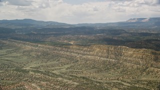 AX130_396 - 5.5K aerial stock footage of approaching a mountain ridge from a wide valley, Grand Staircase-Escalante National Monument, Utah