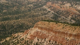AX130_427E - 5.5K aerial stock footage of flying by end of thin mesa with steep slopes, Bryce Canyon National Park, Utah