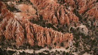 AX130_433 - 5.5K aerial stock footage of bird's eye view flying over hoodoos, buttes, dirt roads, Bryce Canyon National Park, Utah