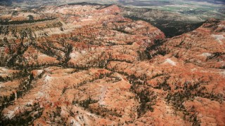 AX130_439 - 5.5K stock footage aerial video of passing by hills, mesa, hoodoos at Bryce Canyon National Park, Utah