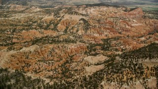 AX130_442E - 5.5K aerial stock footage of buttes, hills, small groups of hoodoos at Bryce Canyon National Park, Utah