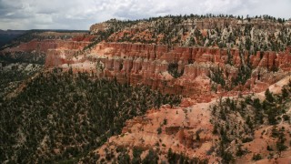 AX130_459 - 5.5K stock footage aerial video of passing by hoodoos on the slope of a mesa, Bryce Canyon National Park, Utah