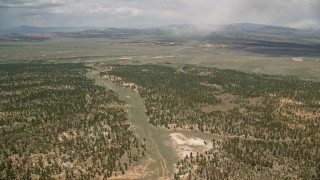 AX130_491E - 5.5K aerial stock footage of flying by forest and valleys outside the national park, Bryce Canyon National Park, Utah