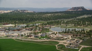 AX131_001E - 5.5K aerial stock footage of orbiting small town, hotels outside Bryce Canyon National Park, Bryce, Utah