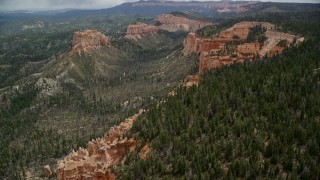 AX131_013E - 5.5K aerial stock footage of flying over cliffs near Mud Canyon Butte, Bryce Canyon National Park, Utah