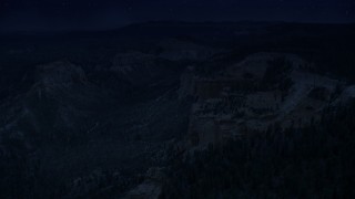 AX131_013_DFN - Aerial stock footage of 4K day for night color corrected aerial footage approach cliff near Swamp/Mud Canyon Buttes, Bryce Canyon National Park, Utah