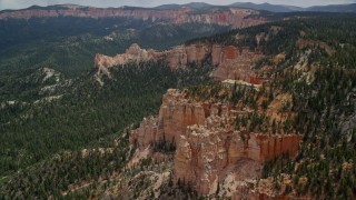 AX131_018E - 5.5K aerial stock footage of approaching and flying over buttes, forest, Bryce Canyon National Park, Utah