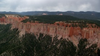 AX131_021 - 5.5K aerial stock footage of flying by rock formations, Pink Cliffs, trees, Bryce Canyon National Park, Utah