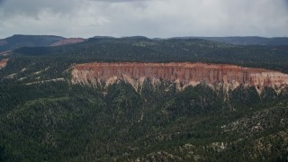 AX131_035 - 5.5K aerial stock footage of flying away from rock formations, Pink Cliffs, Bryce Canyon National Park, Utah