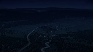 AX131_040_DFN - Aerial stock footage of 4K day for night color corrected aerial footage fly over dirt roads near forest, Grand Staircase-Escalante National Monument, Utah