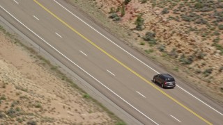AX131_078 - 5.5K aerial stock footage of tracking SUV on Highway 89, Glen Canyon National Recreation Area, Utah, Arizona