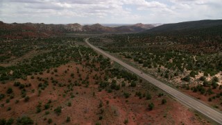 AX131_080 - 5.5K stock footage aerial video of approaching SUV on Highway 89 through Glen Canyon National Recreation Area, Utah, Arizona