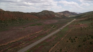 AX131_087 - 5.5K stock footage aerial video of following a big rig and bus on Highway 89, Glen Canyon National Recreation Area, Utah, Arizona