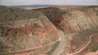 AX131_090 - 5.5K stock footage aerial video track a car on Highway 89, Glen Canyon National Recreation Area, Utah, Arizona