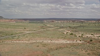 AX131_095E - 5.5K aerial stock footage follow Highway 89, focus on butte, Glen Canyon National Recreation Area, Utah, Arizona