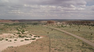 AX131_097 - 5.5K stock footage aerial video follow Highway 89, focus on butte, Glen Canyon National Recreation Area, Utah, Arizona
