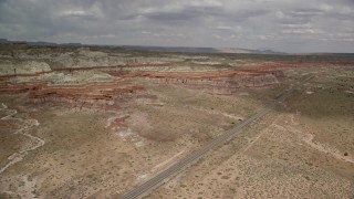 AX131_099E - 5.5K aerial stock footage of following Highway 89 toward rock formations, Glen Canyon National Recreation Area, Utah, Arizona