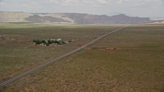 AX131_106 - 5.5K aerial stock footage of Highway 89 by buildings, Glen Canyon National Recreation Area, Utah, Arizona