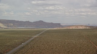 AX131_107E - 5.5K aerial stock footage of flying by Highway 89, reveal small town, Glen Canyon National Recreation Area, Utah, Arizona