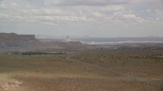 AX131_111 - 5.5K aerial stock footage of approaching a small rural town near Highway 89, Big Water, Utah