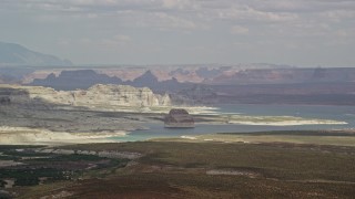 AX131_121 - 5.5K aerial stock footage of Lone Rock and Lake Powell by Glen Canyon National Recreation Area, Utah, Arizona