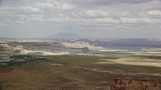 AX131_122 - 5.5K aerial stock footage of passing Lone Rock and Lake Powell by Glen Canyon National Recreation Area, Utah, Arizona