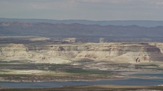 AX131_128 - 5.5K aerial stock footage of flying by mesa and Lake Powell, Glen Canyon National Recreation Area, Utah, Arizona
