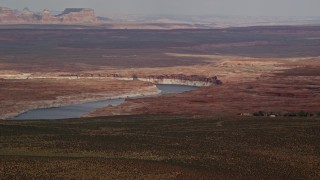 AX131_129E - 5.5K aerial stock footage of passing by Lake Powell and desert, Glen Canyon National Recreation Area, Utah, Arizona