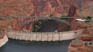 AX131_134 - 5.5K stock footage aerial video of passing the Glen Canyon Dam and Bridge, Arizona