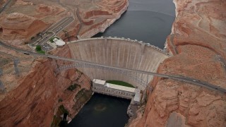 AX131_139E - 5.5K aerial stock footage of circling above the Glen Canyon Dam and Bridge, Arizona