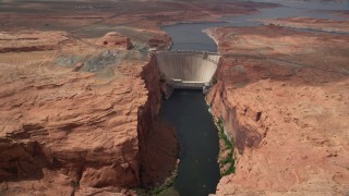 AX131_145 - 5.5K stock footage aerial video of following Colorado River, approaching the Glen Canyon Dam and Bridge, Arizona
