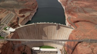 AX131_147 - 5.5K stock footage aerial video approach and tilt to bird's eye of bridge and dam, Lake Powell, Glen Canyon Dam and Bridge, Arizona