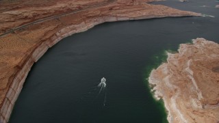 AX131_149 - 5.5K aerial stock footage tilt to bird's eye view of a boat on Lake Powell in Arizona